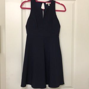 Navy fit and flare dress with back bow details!